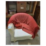White Barrel Armchair with Red Striped Throw Blanket