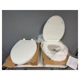 Two White Oblong Toilet Seats.  Unused. (One missing attachment pieces)