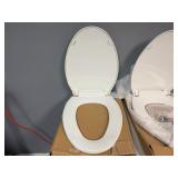Two White Oblong Toilet Seats.  Unused. (One missing attachment pieces)