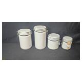 Home Decor Lot with 2 Wall Clocks, Ceramic Canisters, Candles, and Vase