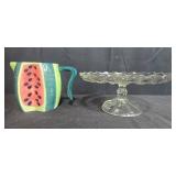Kitchen Decor Lot with Watermelon Pitcher, Glass Cake Stand, and 2 Jeanne Down Collector Plates
