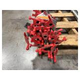 Black pipe bars, various lengths with red pipe clamps that have swing handles