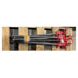 Black pipe bars with red pipe clamps that have swing handles