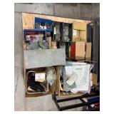 Pallet of Hardware, parts cabinet, a 6-shelf open metal storage unit, a black heavy-duty rail bin rack.