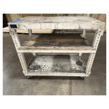 Mobile workbench with open sides and a middle and lower shelf. 43” x 24"