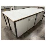 Steel base w/laminated 4x8 top: bottom has one side open, one side retrofitted w/drawers & 2-door cabinet
