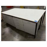 Steel base w/laminated 4x8 top: bottom has one side open, one side retrofitted w/drawers & 2-door cabinet