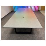 Conference table with four U-shaped metal leg supports.