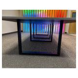 Conference table with four U-shaped metal leg supports.