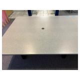 Conference table with four U-shaped metal leg supports.