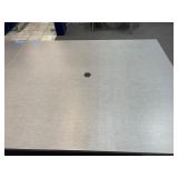 Conference table with four U-shaped metal leg supports.