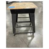 (3) work benches, metal w/wood top, all-wood table, black metal cart on casters. (1)stool w/metal frame