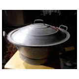 Huge metal pot, like a wok.