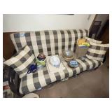 Black Metal Futon with Plaid Cushions and Pillows