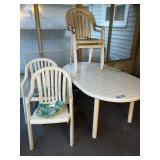 Outdoor Patio Set with Oval Table and 4 White Plastic Armchairs