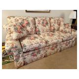 Floral Upholstered Sofa with Rolled Arms and Skirted Base