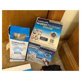 Group of Waterpik Water Flossers, CVS Digital Body Scale, Cosmetic Bags, and Accessories