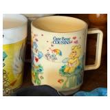 Vintage Collectibles Lot with Care Bear Mug, Wooden Blocks, Pottery, Figurines, and Ephemera