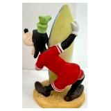 Collection of 13 Vintage Figurines and Dolls Including Goofy, Matryoshka, and Character Pieces