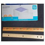 Assorted Office Supplies Lot Including Paper, Envelopes, Rulers, and Binder - contents unverified