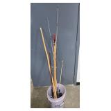 Collection of Vintage and Modern Fishing Rods with Reels in Bucket