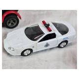 Toy vehicles including a Tonka vintage car, a Chevrolet police car, and a J.T. Wilson truck