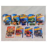 Hot Wheels and Matchbox Die-Cast Vehicles Collection featuring models such as the Hot Wheels "Quick Bite," "Hiway Hauler 2," "Ultimate T-Rex Transporter," and the Matchbox "MBX Self-Driving Bus."