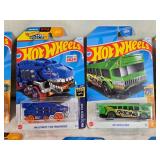 Hot Wheels and Matchbox Die-Cast Vehicles Collection featuring models such as the Hot Wheels "Quick Bite," "Hiway Hauler 2," "Ultimate T-Rex Transporter," and the Matchbox "MBX Self-Driving Bus."
