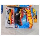 Hot Wheels and Matchbox Die-Cast Vehicles Collection featuring models such as the Hot Wheels "Quick Bite," "Hiway Hauler 2," "Ultimate T-Rex Transporter," and the Matchbox "MBX Self-Driving Bus."