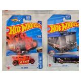 Hot Wheels and Matchbox Die-Cast Vehicles Collection featuring models such as the Hot Wheels "Quick Bite," "Hiway Hauler 2," "Ultimate T-Rex Transporter," and the Matchbox "MBX Self-Driving Bus."