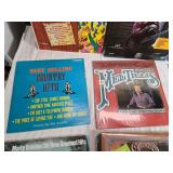 Variety of vinyl records featuring notable country and pop artists such as Sam & Kirk McGee, Del Shannon, Carl Smith, Mel Tillis, Marty Robbins, The Carpenters, Johnny Duncan, Mickey Gilley, Charlie R