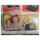 Variety of vinyl records featuring notable country and pop artists such as Sam & Kirk McGee, Del Shannon, Carl Smith, Mel Tillis, Marty Robbins, The Carpenters, Johnny Duncan, Mickey Gilley, Charlie R