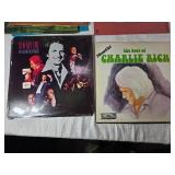 Variety of vinyl records featuring notable country and pop artists such as Sam & Kirk McGee, Del Shannon, Carl Smith, Mel Tillis, Marty Robbins, The Carpenters, Johnny Duncan, Mickey Gilley, Charlie R