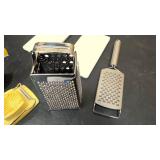 two Cheese graders, two Egg dishes, slicer, and press