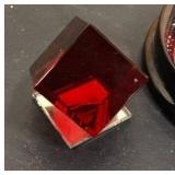 Living room décor = Red cube, clock with globe, and decorative small dish