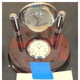 Living room décor = Red cube, clock with globe, and decorative small dish