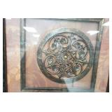 Framed Wall Hanging with an Ornate Metal Medallion Design