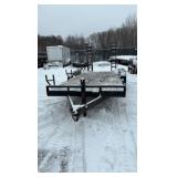 2002 PJ Flatbed equipment trailer with two loa with two loading ramps.