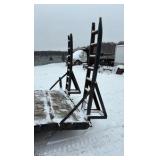 2002 PJ Flatbed equipment trailer with two loa with two loading ramps.