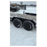 2002 PJ Flatbed equipment trailer with two loa with two loading ramps.