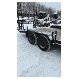 2002 PJ Flatbed equipment trailer with two loa with two loading ramps.
