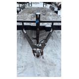 2002 PJ Flatbed equipment trailer with two loa with two loading ramps.