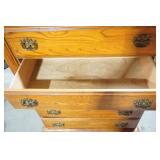 Wooden 5-drawer dresser with ornate brass-toned hardware