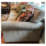 SR - Grey Upholstered Couch with Floral and Green Throw Pillows