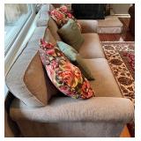SR - Grey Upholstered Couch with Floral and Green Throw Pillows
