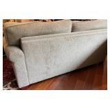 SR - Grey Upholstered Couch with Floral and Green Throw Pillows