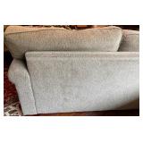 SR - Grey Upholstered Couch with Floral and Green Throw Pillows