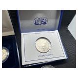 Five Coins: 1958 and 1959 Proof Jefferson Nickels; 1999 Proof Susan B. Anthony Dollar in U. S. Mint Package with COA; Two 1986-D Uncirculated Half Dollars