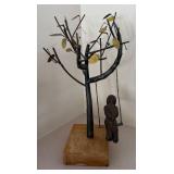 LL  - Metal Sculpture of Child on Swing Under Tree