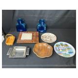 Eclectic Decorative Collection with Blue Glass Bottles, Plates, Wood Dish, and Longaberger Basket